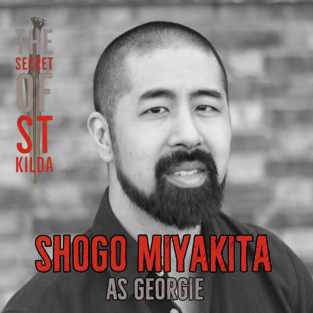 Shogo Miyakita as Georgie. Smiling black and white headshot of asian man with shaved head and full beard.