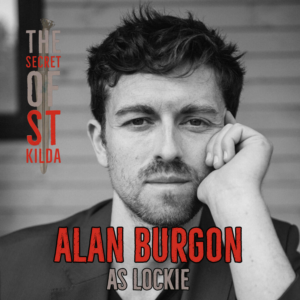 Alan Burgon as Lockie. Serious black and white headshot of white man with short dark hair and beard stubble leaning on one hand