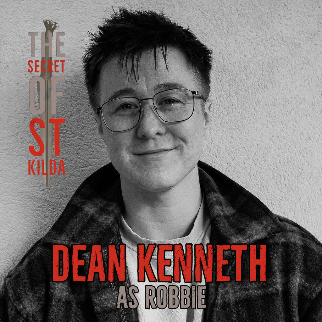Dean Kenneth as Robbie. Smiling black and white headshot of white man with very short blonde hair.